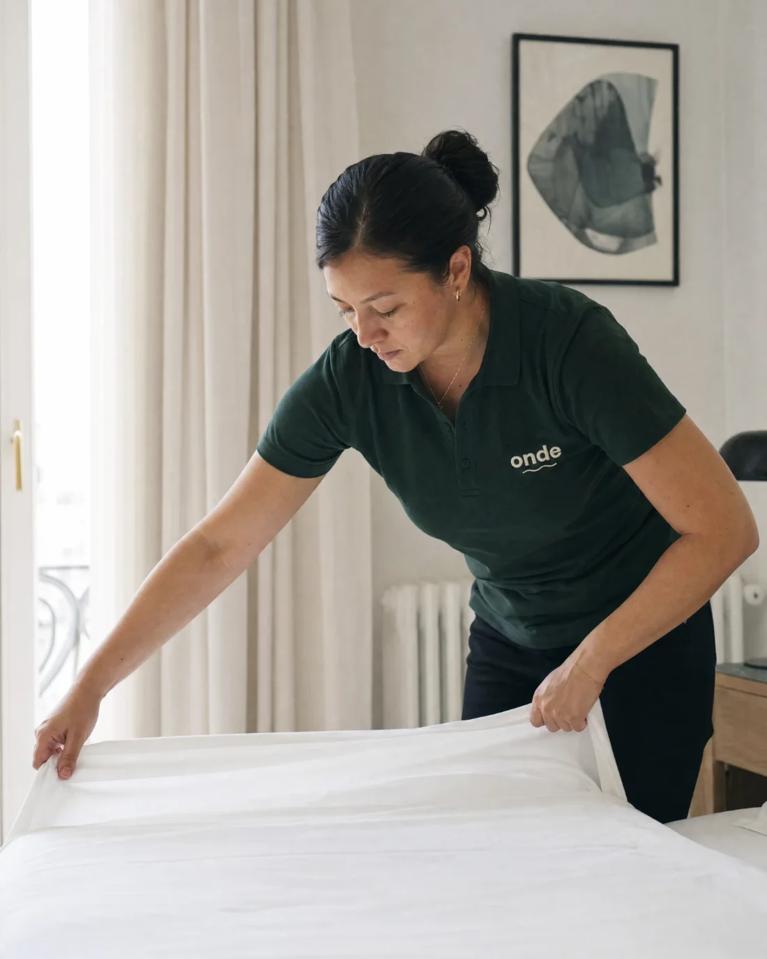Membre de l'équipe ONDE préparant un lit entre deux séjours